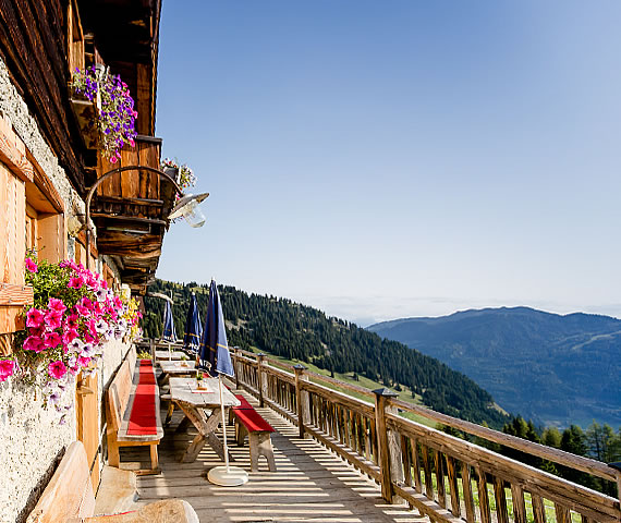 sunny day in wagrain, old hut in the mountains with terrasse and panoramic view